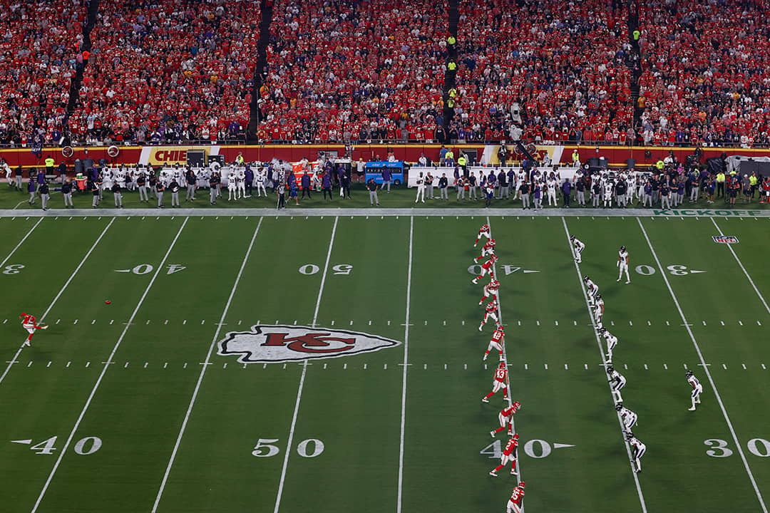 Kansas City Chiefs' No. 7 Harrison Butker kicking the ball on the games opening kickoff across Baltimore Ravens players at the Arrowhead Stadium in Kansas City, Missouri, USA.